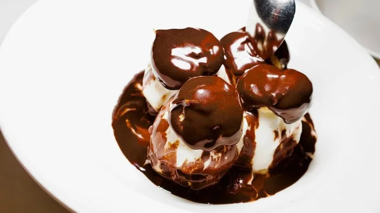 A spoon dips into a fancy dessert.