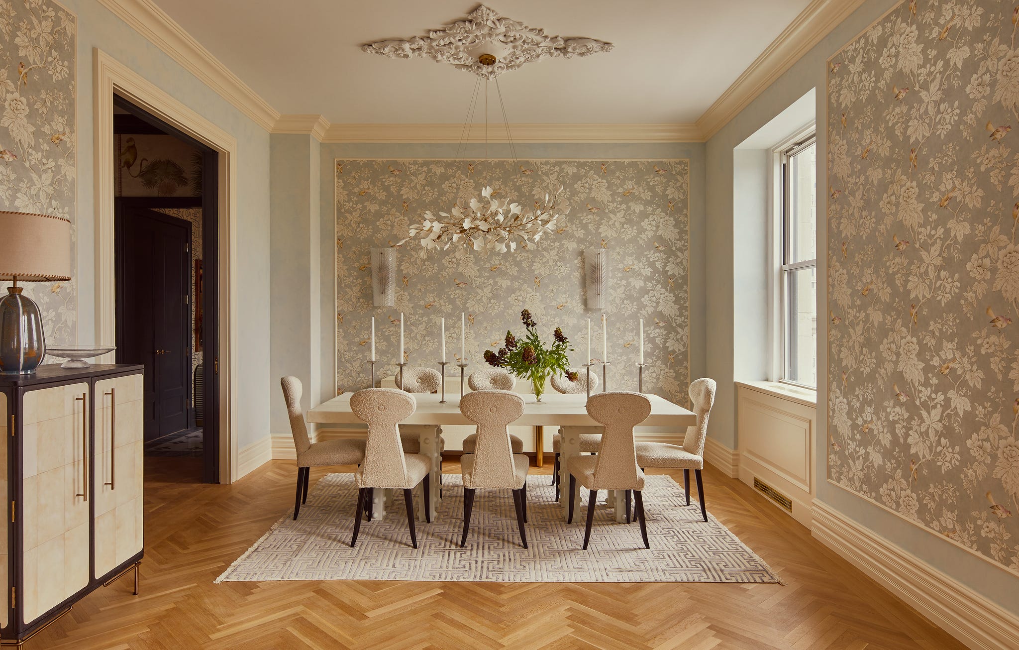 Elegant dining room featuring a table, chairs, and decorative elements.