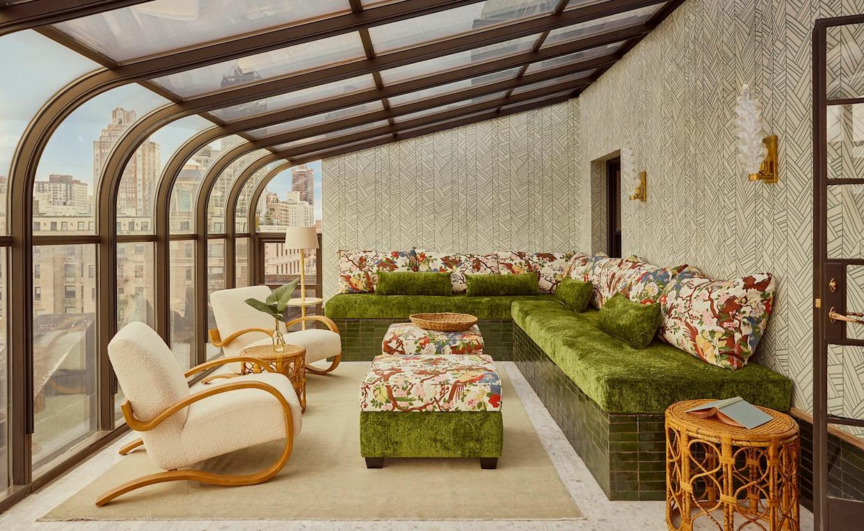 Bright sunroom with modern furnishings and city views.