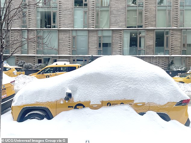 An iconic New York City yellow cab is pictured buried in snow. The cold snap this year was the longest since 2018