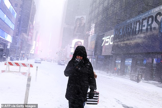 A woman is pictured walking in New York City on January 25 during a winter storm that dumped almost a foot of snow on the city. A 16-day-long streak of nearly freezing and below-freezing temperatures began on January 24
