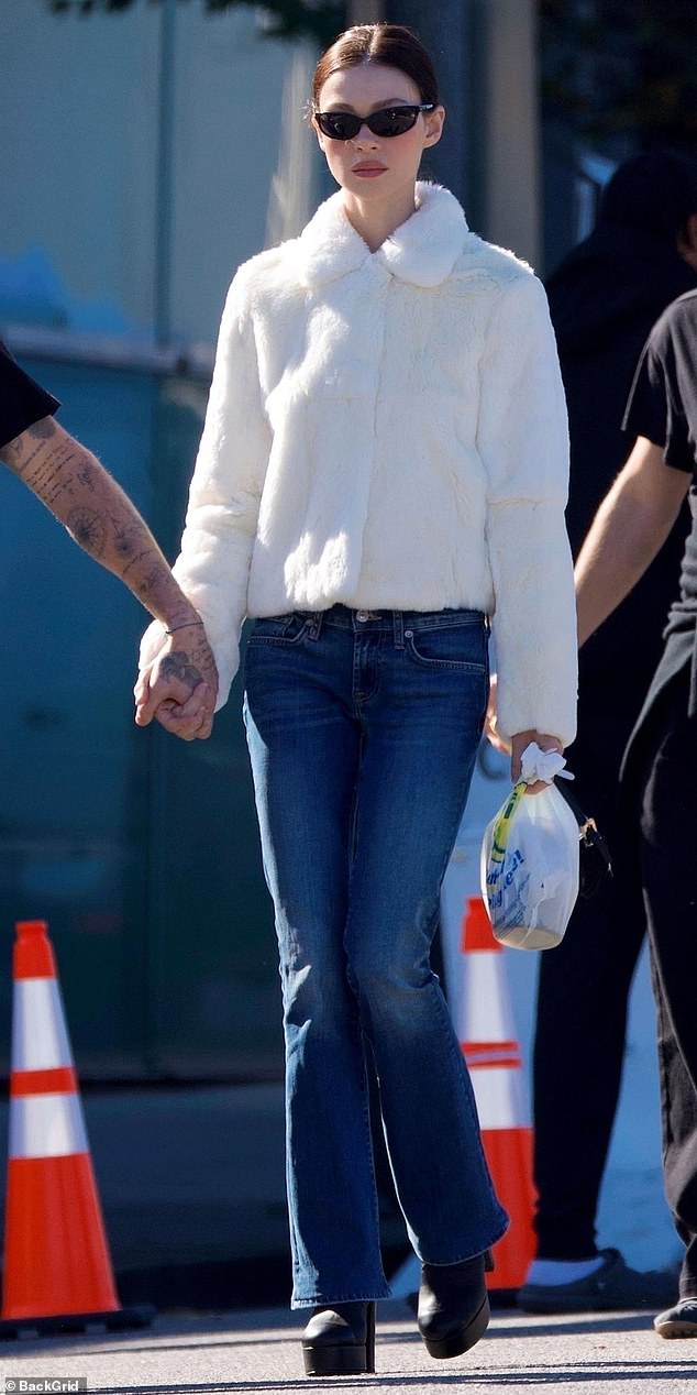 Nicola (pictured) donned a cream jacket and platform boots on a ‘low key’ outing to a farmers’ market near the couple's home in Beverly Hills