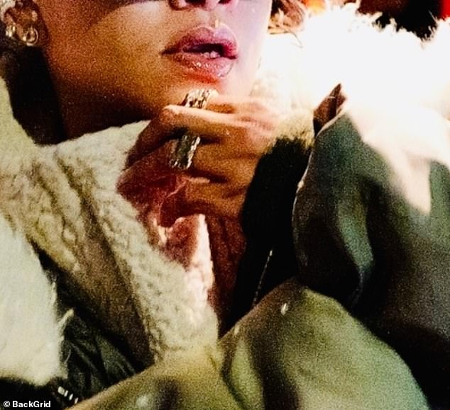 Sweeping back her long brunette locks into a casual ponytail she accessorised with diamond earrings as well as a ring on her wedding finger