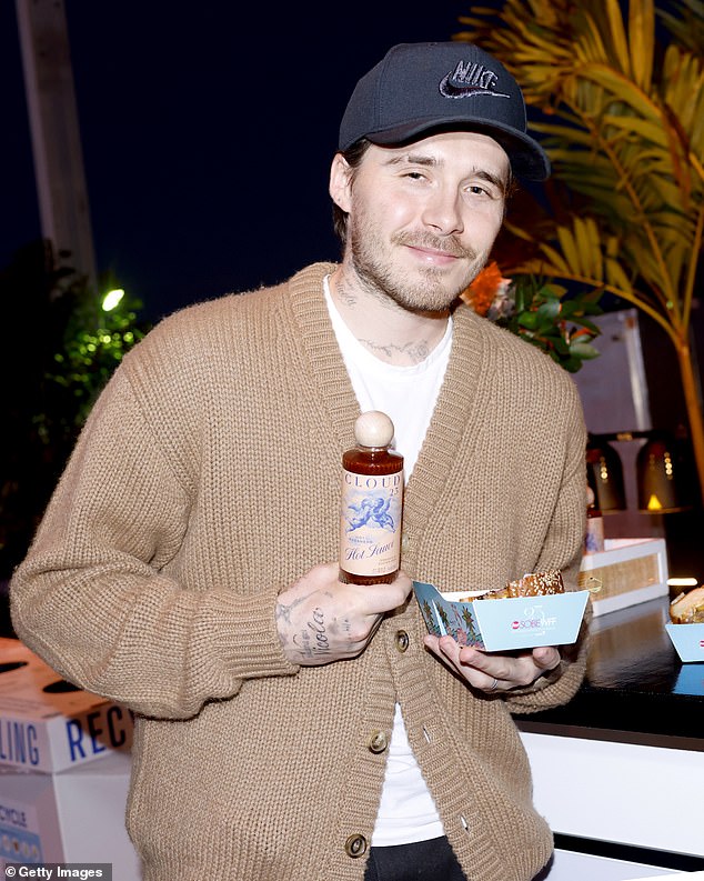 Brooklyn Beckham covered up his arms as he promoted his hot sauce range at a food festival on Thursday - after he was at spotted wearing a £220k watch gifted by his dad David earlier this week