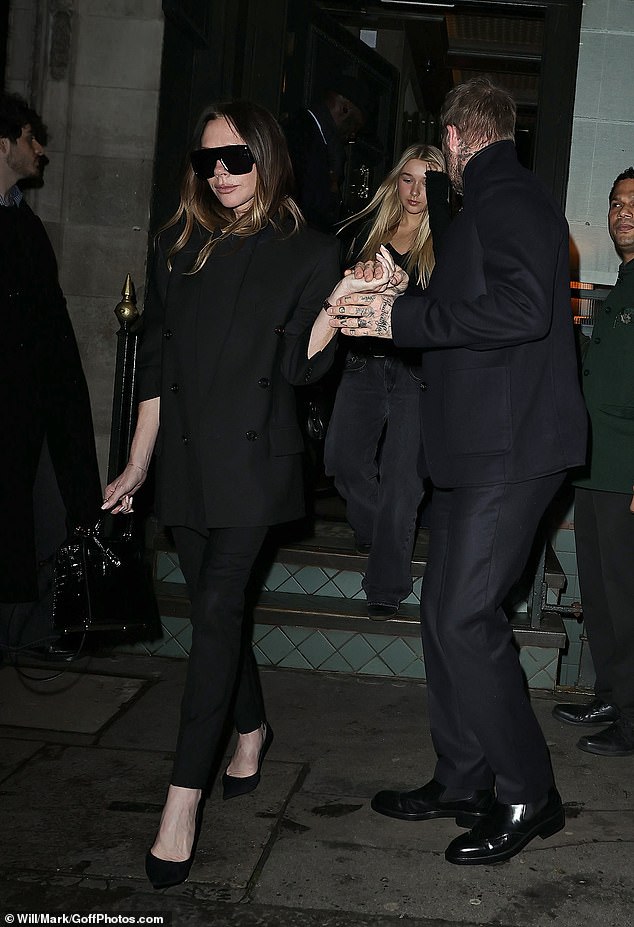 David was every inch the loving husband and father as he held out a hand as they walked down the steps