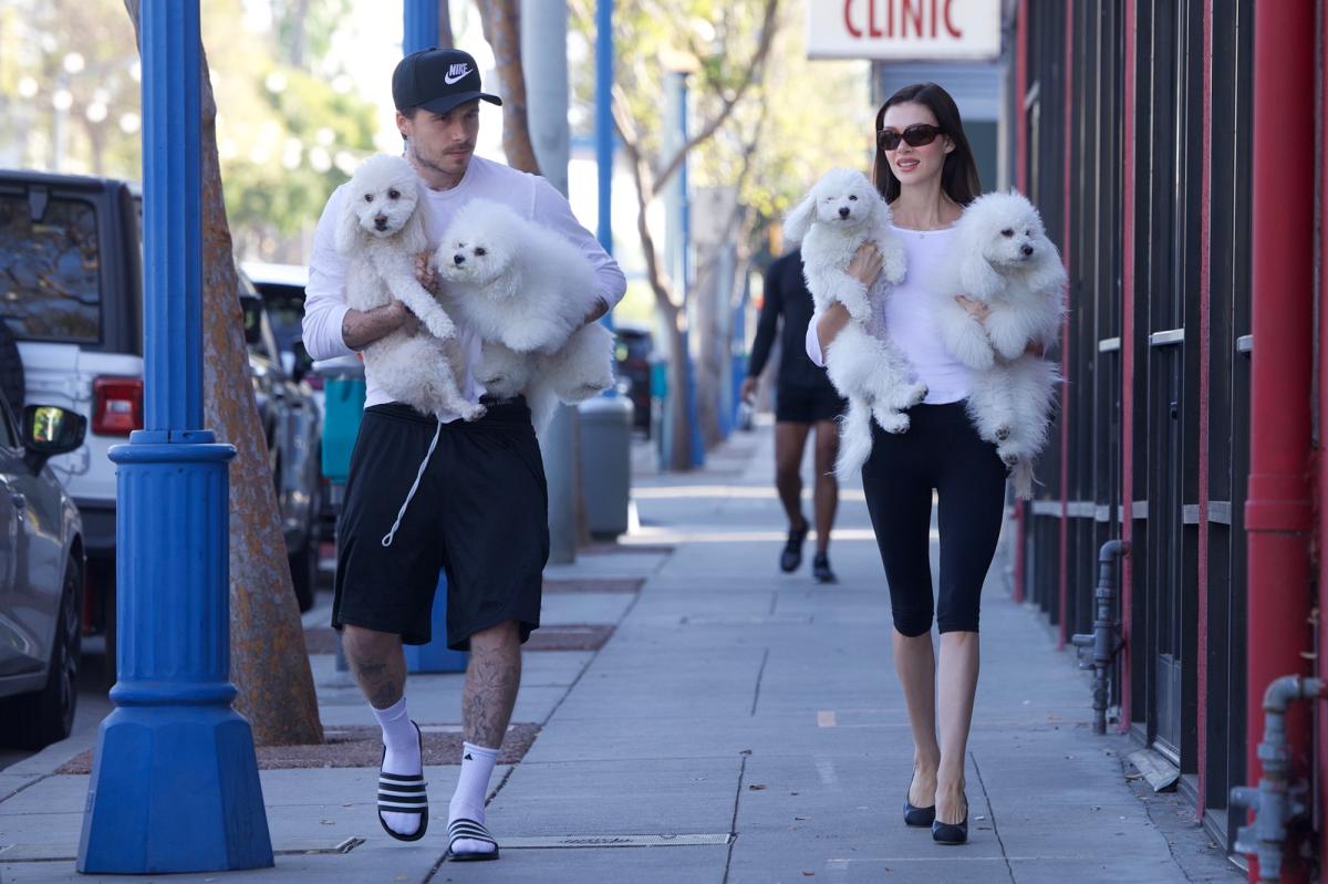 Brooklyn Beckham, Nicola Peltz twin with their dogs in black and white outfits