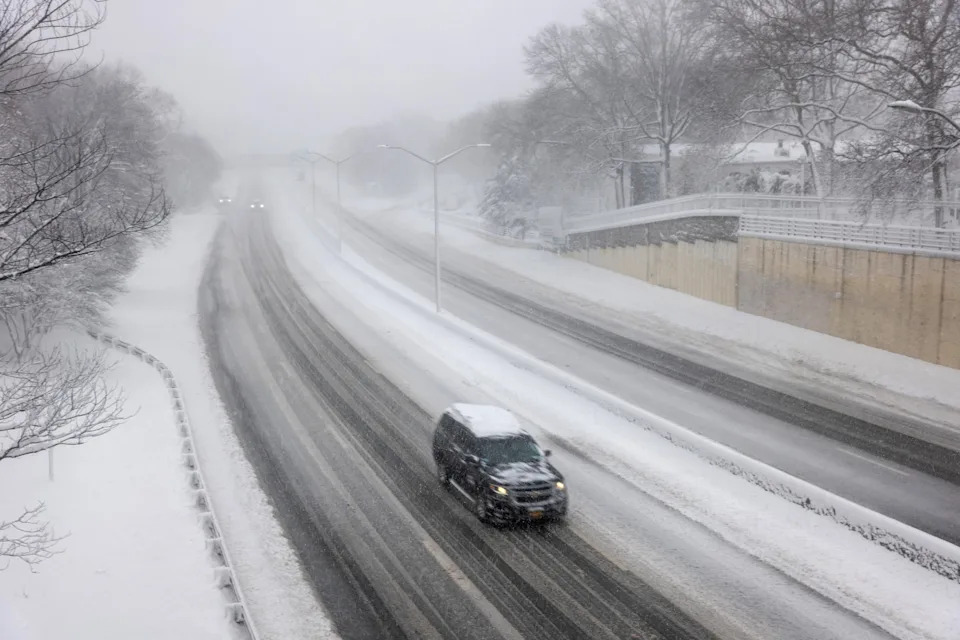 Spencer Platt/Getty Images - PHOTO: Few cars move along a Brooklyn highway as blizzard conditions continue, Feb. 23, 2026, in New York. New York City Mayor Zohran Mamdani announced a state of emergency yesterday for New York City and issued a travel ban until 12 p.m. on Monday.
