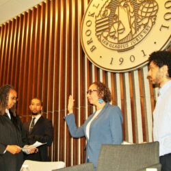 Hon. Juliet Howard being sworn in by Hon. Norma Jennings alongside their sons. Brooklyn Eagle photo by Mario Belluomo