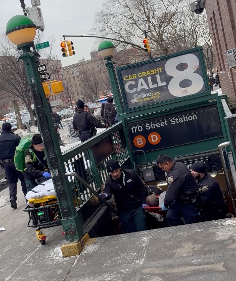 First responders rendering aid to a shooting victim being brought out of the 170th Street subway station.