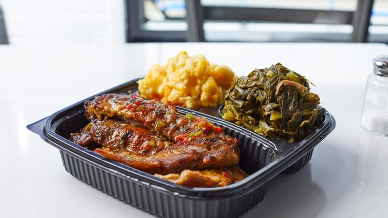 Smothered turkey wings with collard greens and macaroni-and-cheese at Lola's Southern...