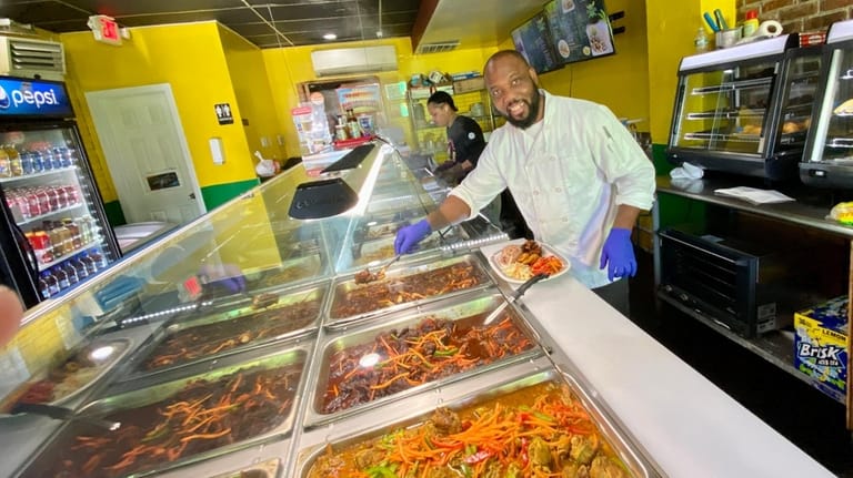Chef Kwame McNeil at Stop 'n Nyamm in Shirley smokes the...