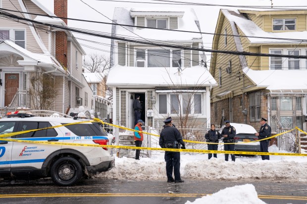 Police respond to a home on Parsons Boulevard in Queens on Monday after a man was shot and wounded by NYPD cops.