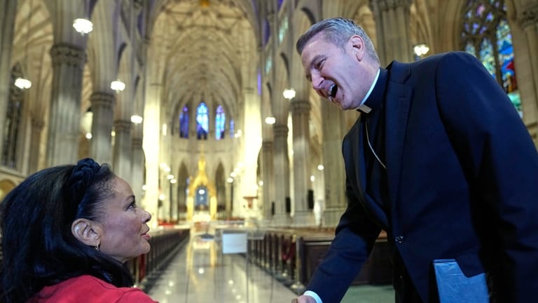 Archbishop-designate Ronald Hicks greets journalists before a news conference at...