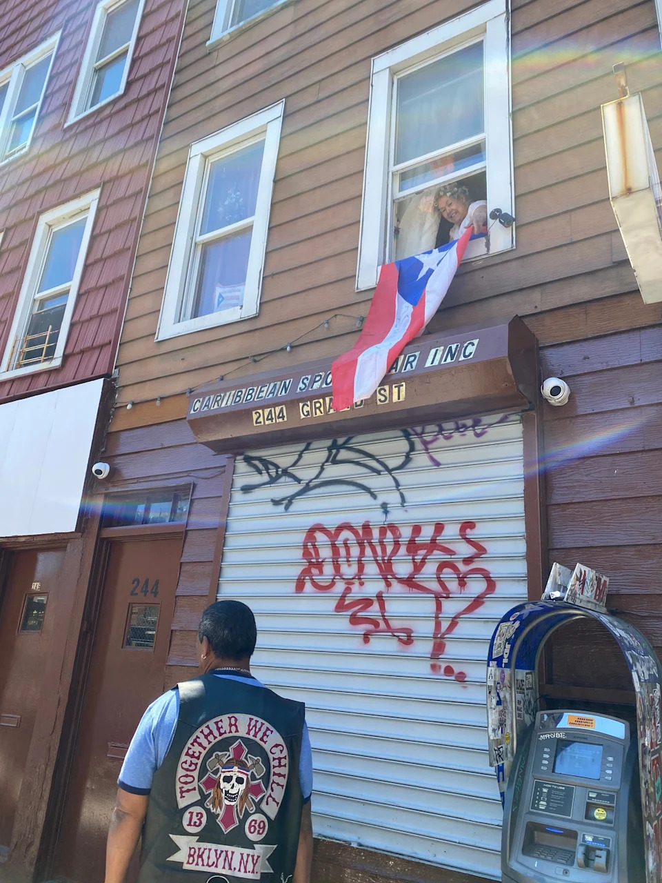 Toñita hangs a Puerto Rican flag from the apartment she lives in above her club.