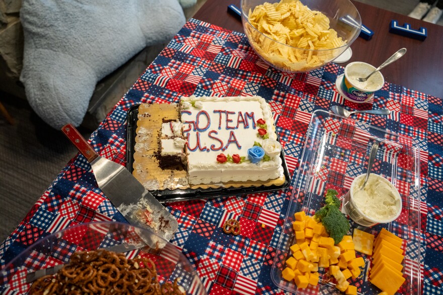 The Bishop Kearney girls U16 and U19 hockey teams were let out of class early to watch the US-Canada game from their community room, which was decorated with balloons and full of snacks, including a frosted cake that read "GO TEAM USA."