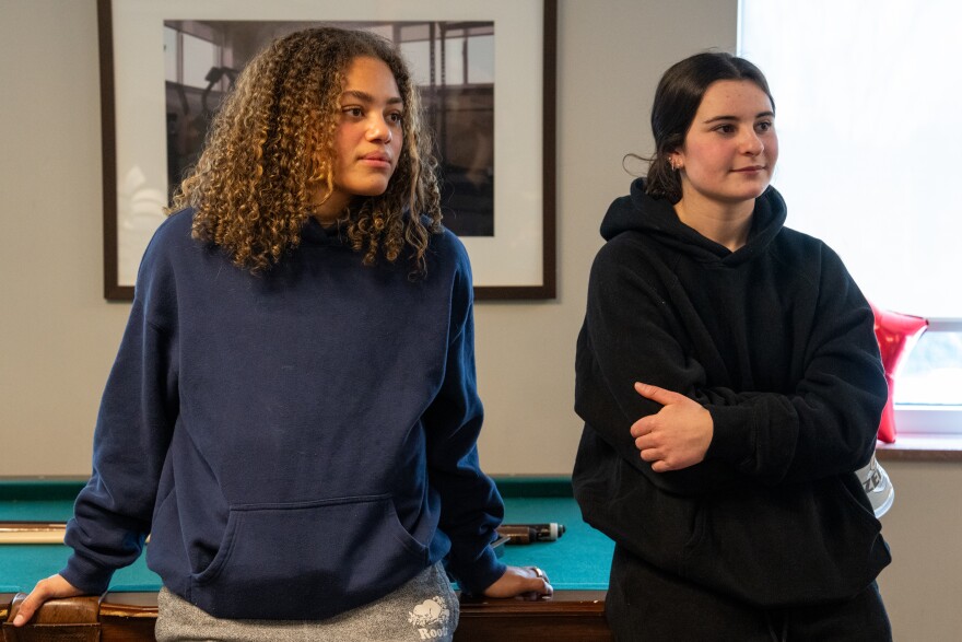 Chloe Brinson and Micayla Hunt, players on the BK Selects hockey team, watch the United States vs. Canada women’s Olympic hockey match with their teammates on Tue, Feb 10, 2026 at Bishop Kearney High School in Irondequoit.