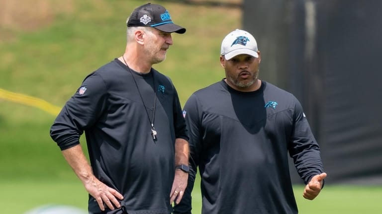 Then-Panthers coach Frank Reich talks with assistant head coach/running backs coach...