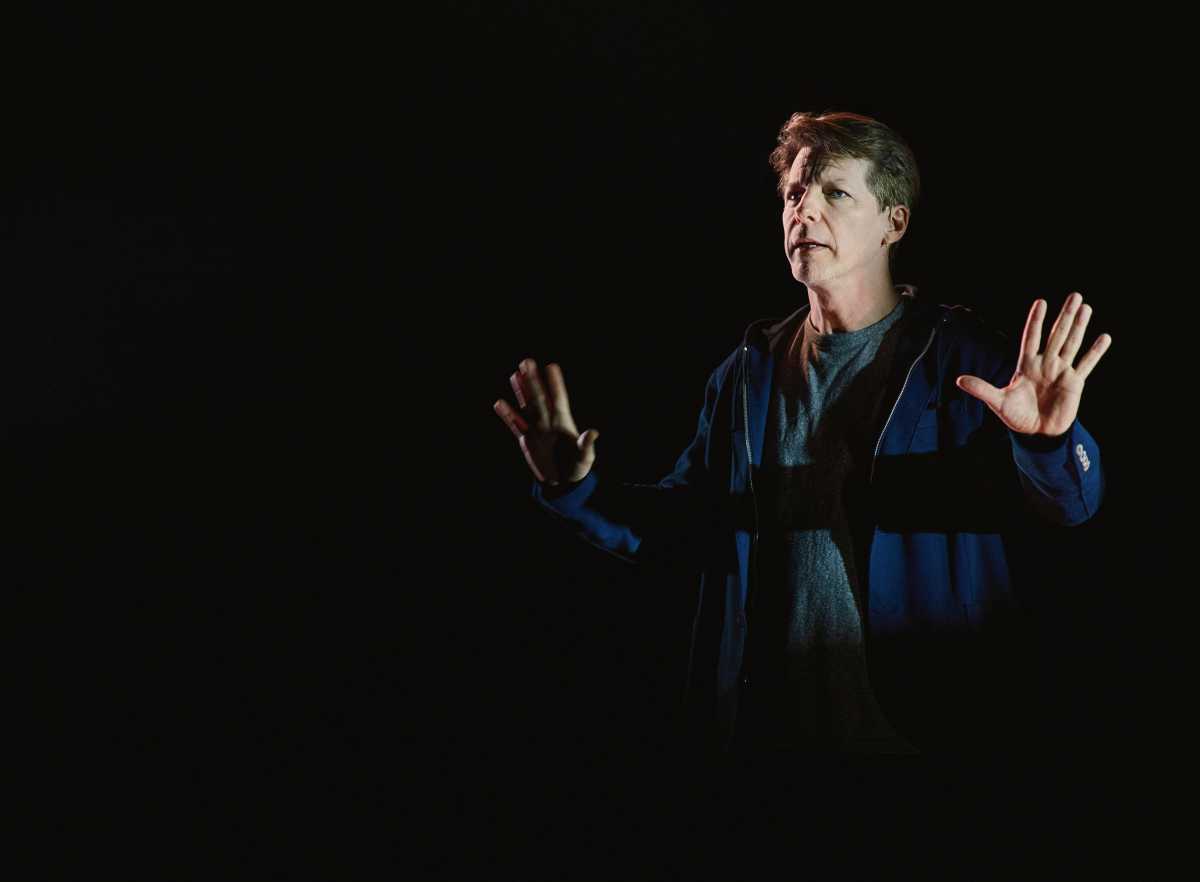 an actor who looks serious performing on stage