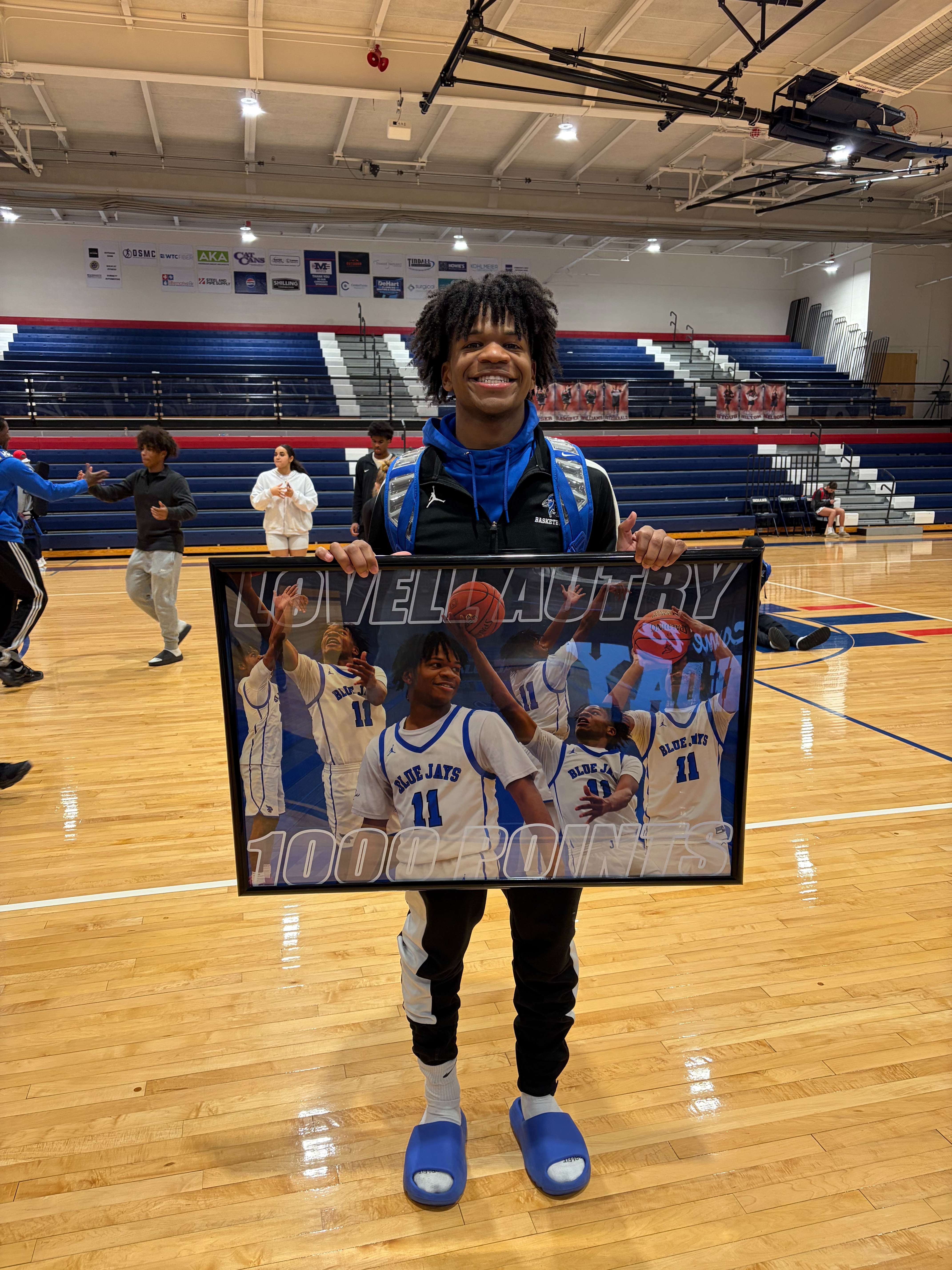 Lovell Autry 1,000 career points. The Junction City High School basketball team presented this to him after the win.
