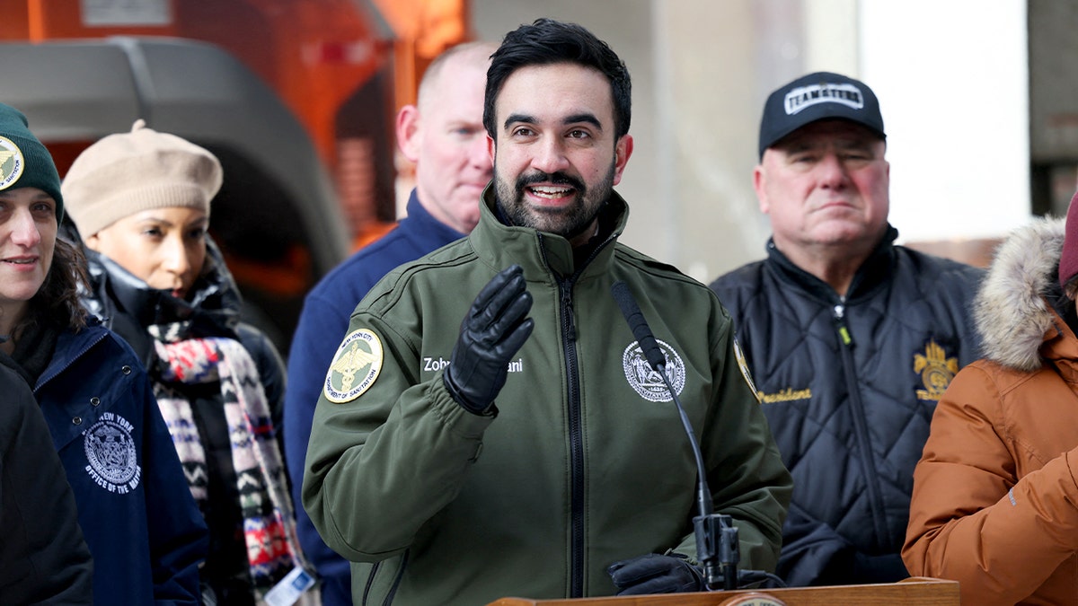 A city official addresses reporters at a podium during an indoor briefing.