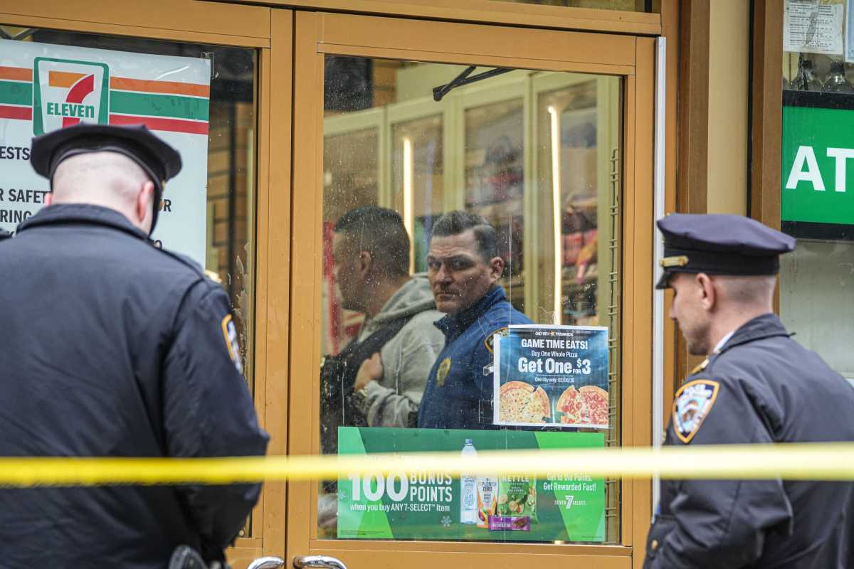 cop looking out window of 7-Eleven in Midtown where man was shot dead