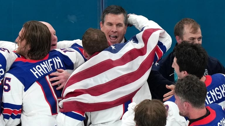 United States head coach Mike Sullivan, top center, gets a...