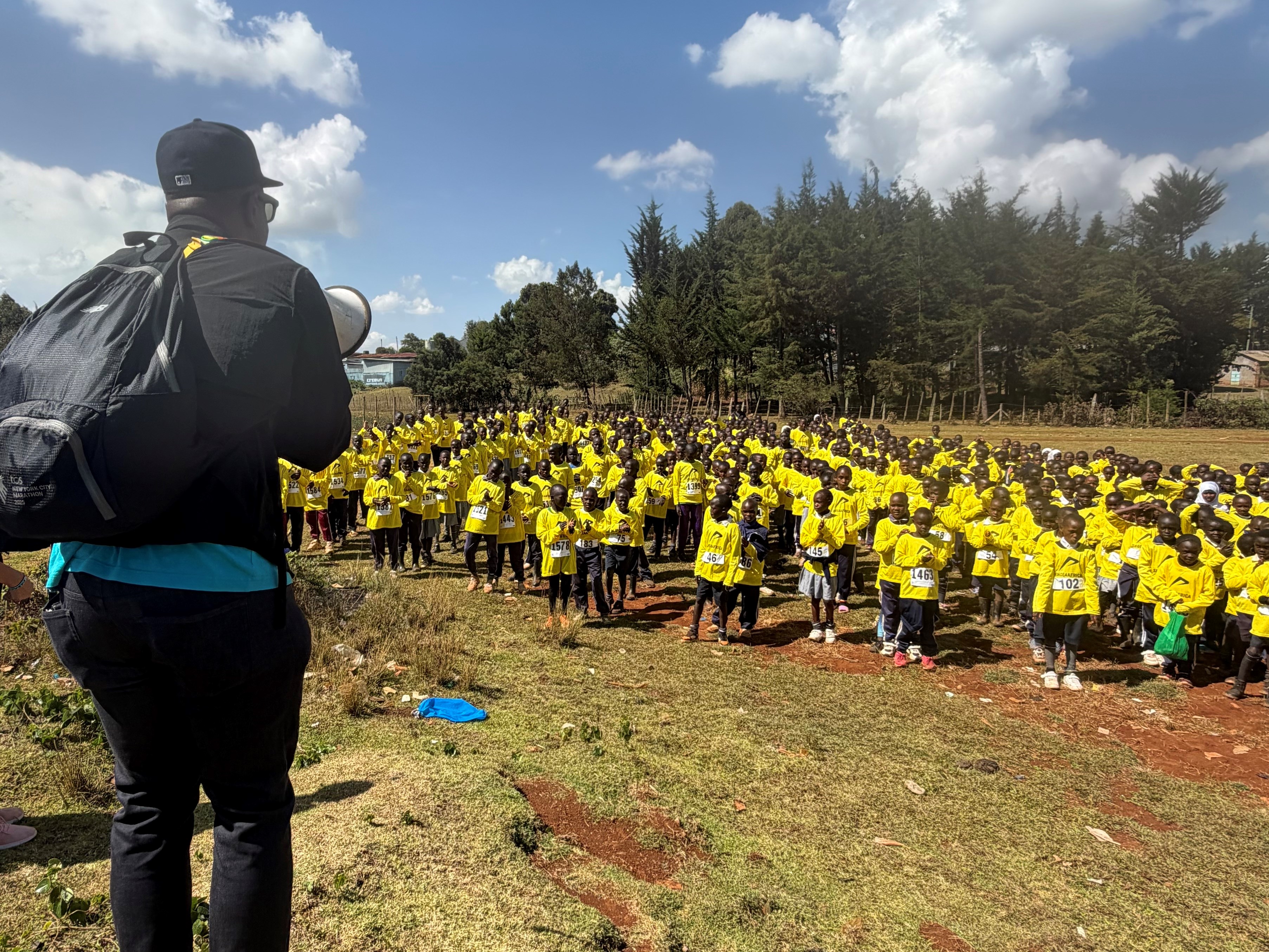 Ted Metellus addresses participants of the Run for the Books at the Shoe4Africa Kids Club, Kenya, February 2026.
