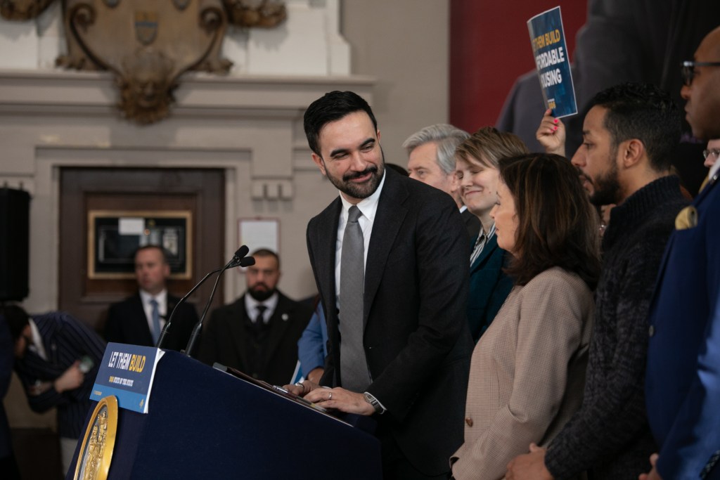 Mayor Zohran Mamdani speaks alongside Gov. Kathy Hochul at the Bedford Armory about cutting bureaucratic red tape for construction projects,