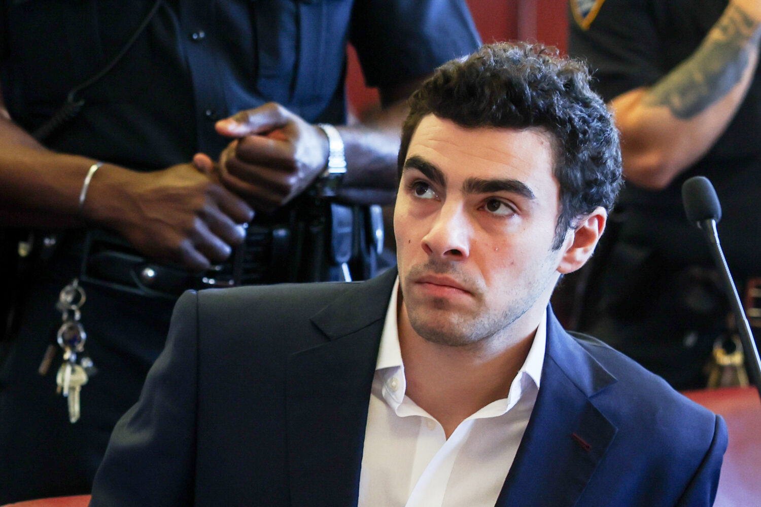 FILE - Luigi Mangione appears in Manhattan Criminal Court for an evidence hearing, Dec. 18, 2025, i...