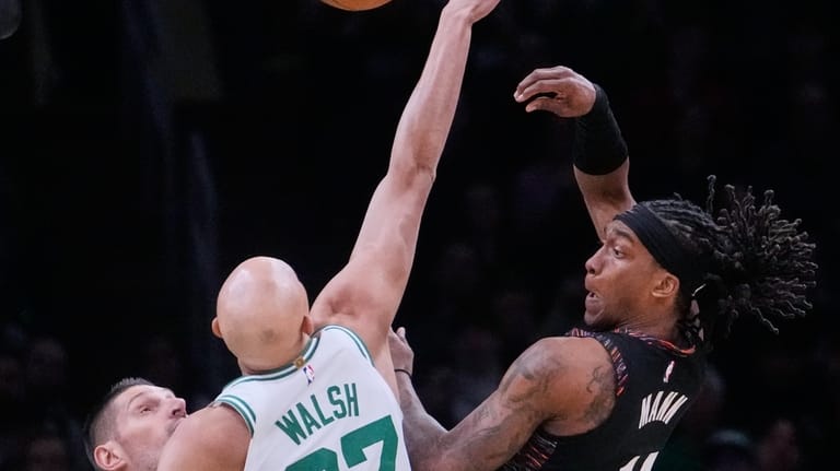 Brooklyn Nets guard Terance Mann, right, passes the ball while...