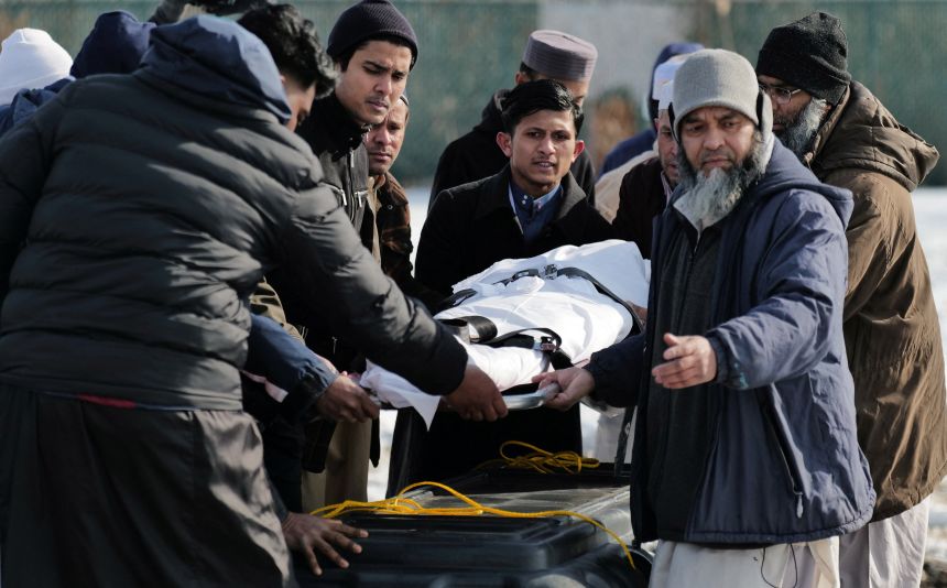 Community members and loved ones toss soil on the burial site of Nurul Amin Shah Alam in Buffalo, New York, on Thursday.