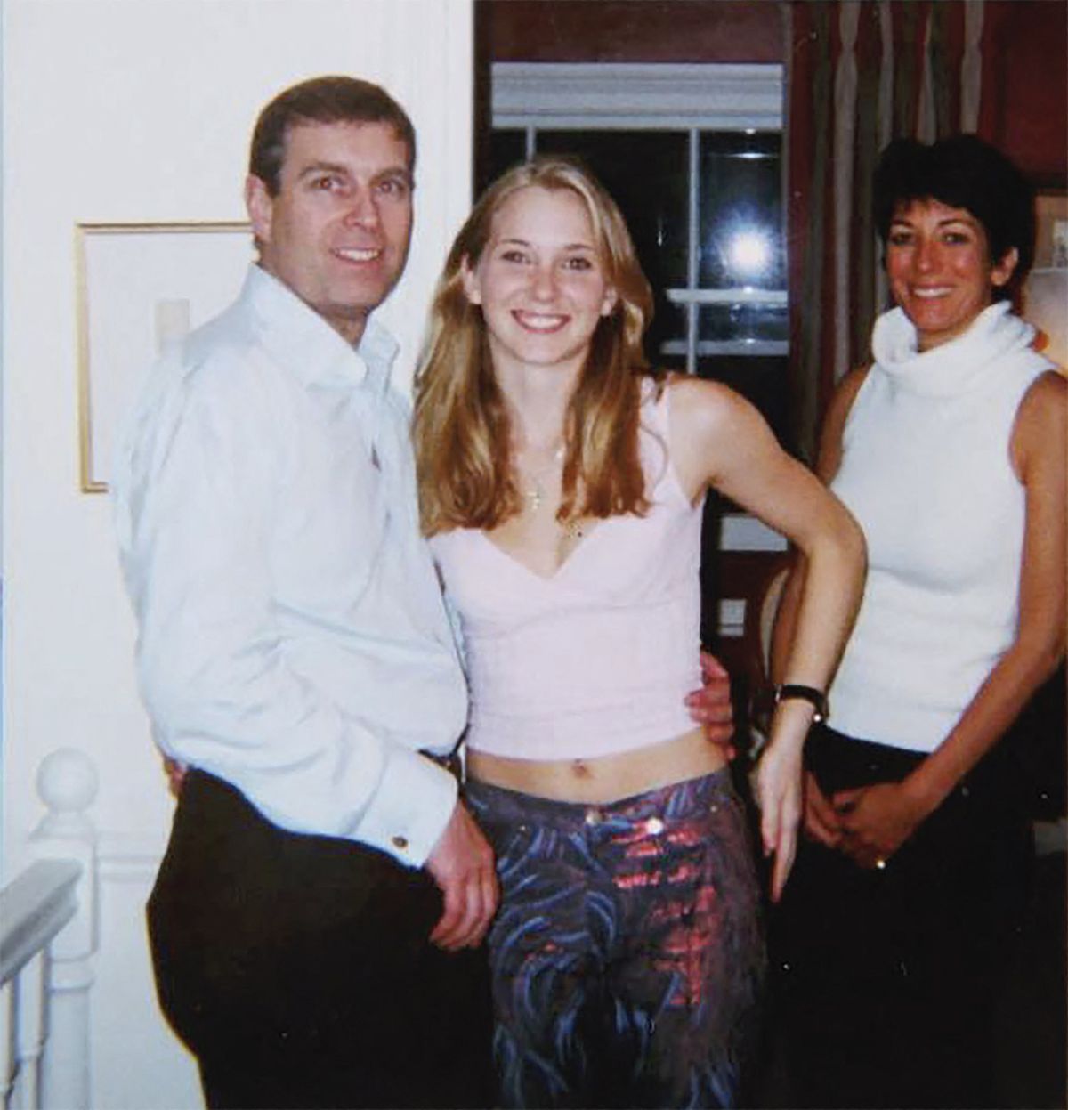 Then-Prince Andrew, Virginia Giuffre, and Ghislaine Maxwell posing for a photo.