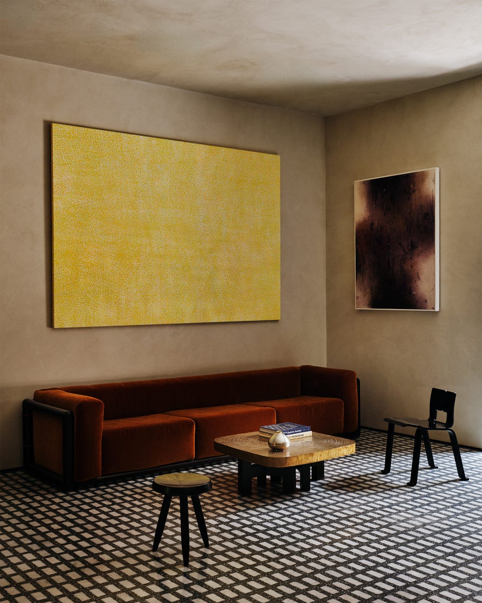 Modern living room with artwork and furniture.