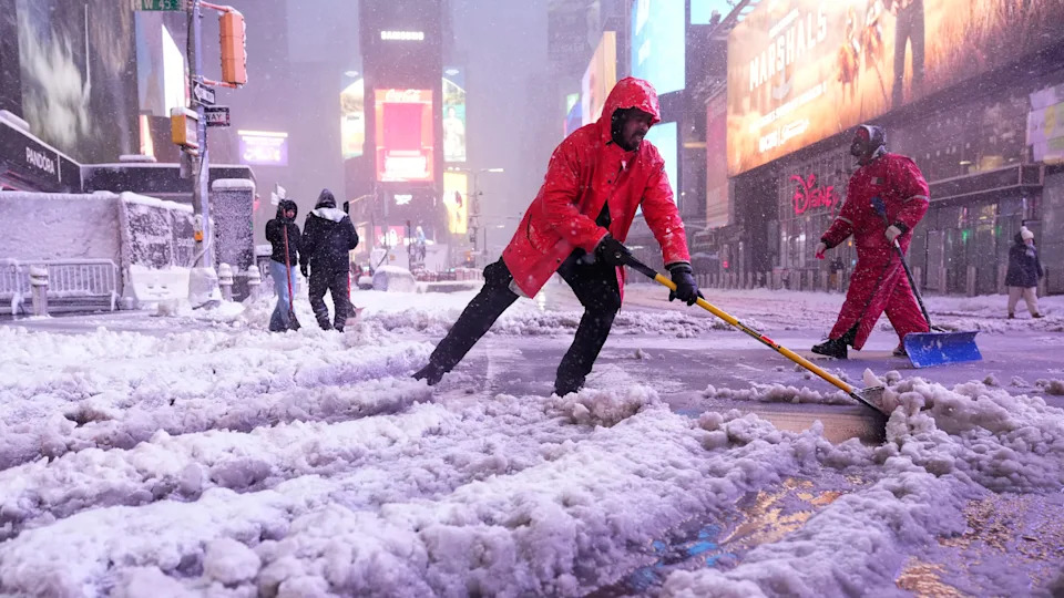 New Yorkers shoveling snow in Times Square<span> Credit: AP </span>