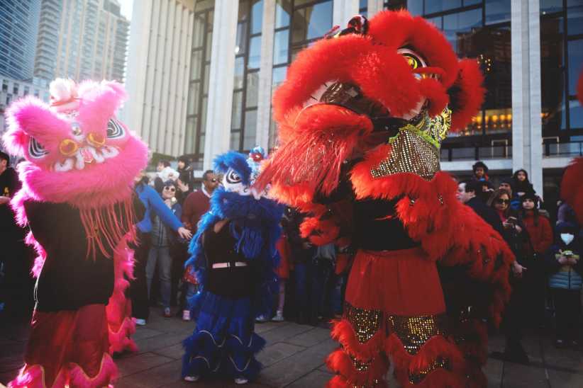 People dancing in costume at Lunar New Year celebration at Lincoln Center. 