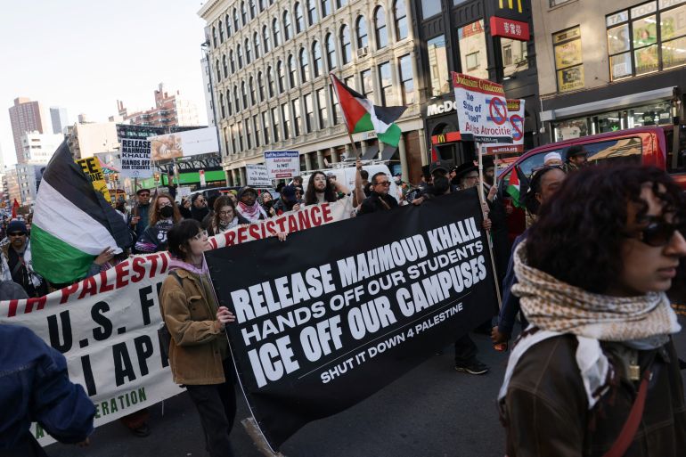 Demonstrators hold banners as they march during a protest following the arrest by US immigration agents of Palestinian student protester Mahmoud Khalil at Columbia University, in New York City, U.S., March 10, 2025. REUTERS/Jeenah Moon