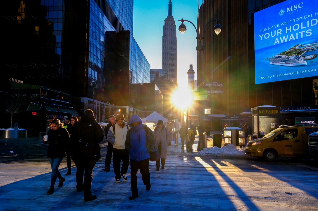 Commuters walk along icy sidewalks in New York City during a cold spell.