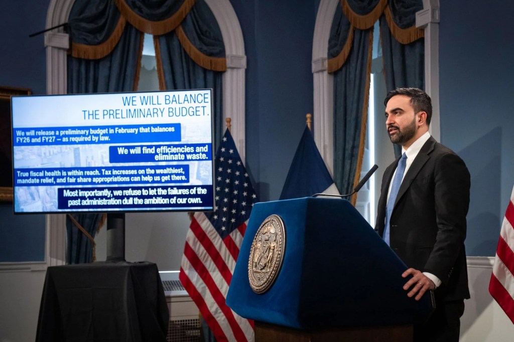 Mayor Mamdani briefing on the city's budget, with a screen displaying "We will balance the preliminary budget."