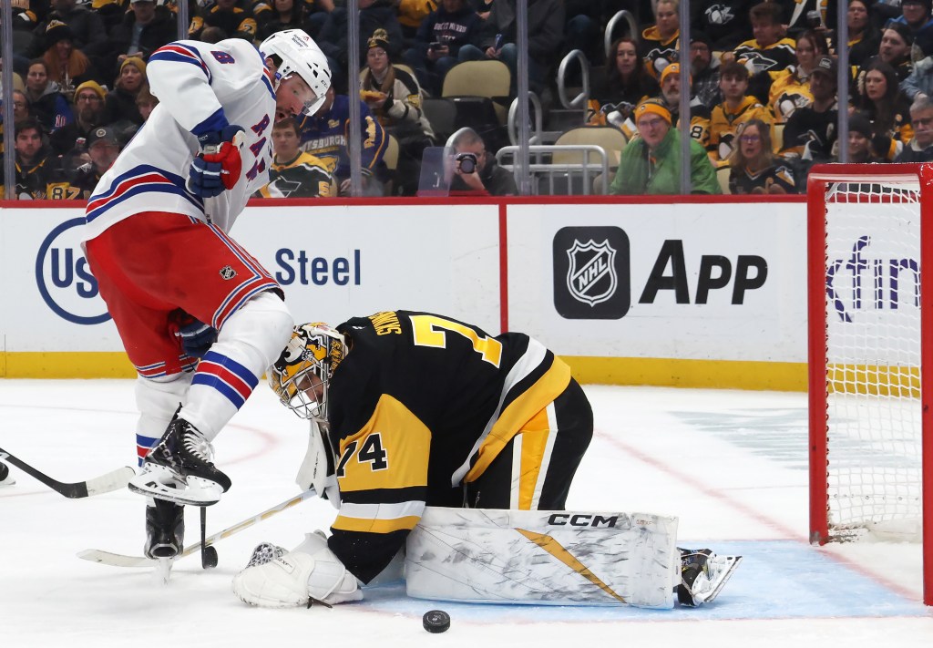 Pittsburgh Penguins goaltender Stuart Skinner (74) make a save against New York Rangers center J.T. Miller (8) during the second period at PPG Paints Arena. 