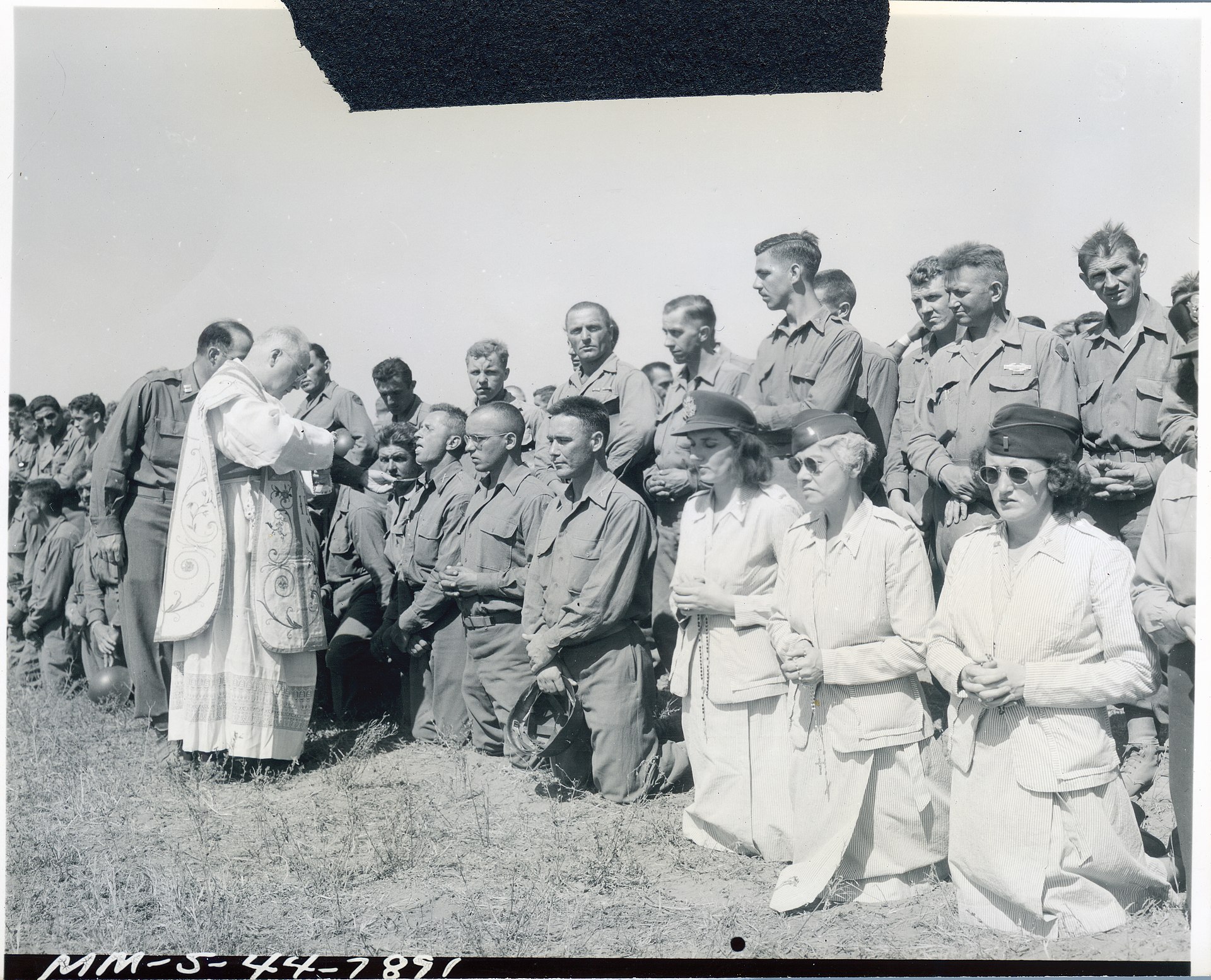 Archbishop Spellman distributing holy communion at mass during a visit to the US Fifth Army in Italy 1944 during World War II.