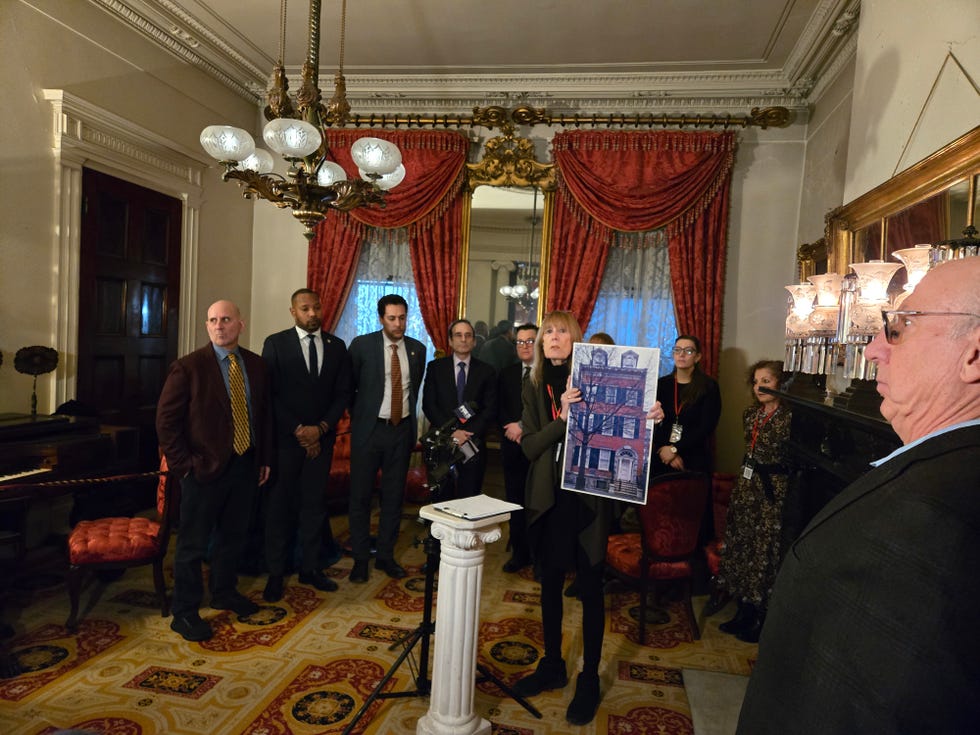group presentation in an indoor setting featuring historical architecture