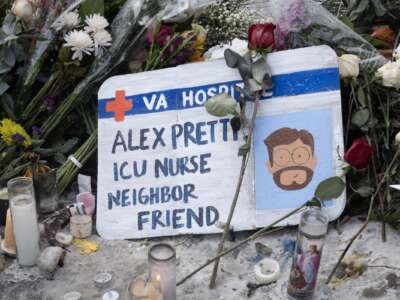 Flowers, candles and a homemade sign make up a memorial to Alex Pretti on January 25, 2026 in Minneapolis, Minnesota.