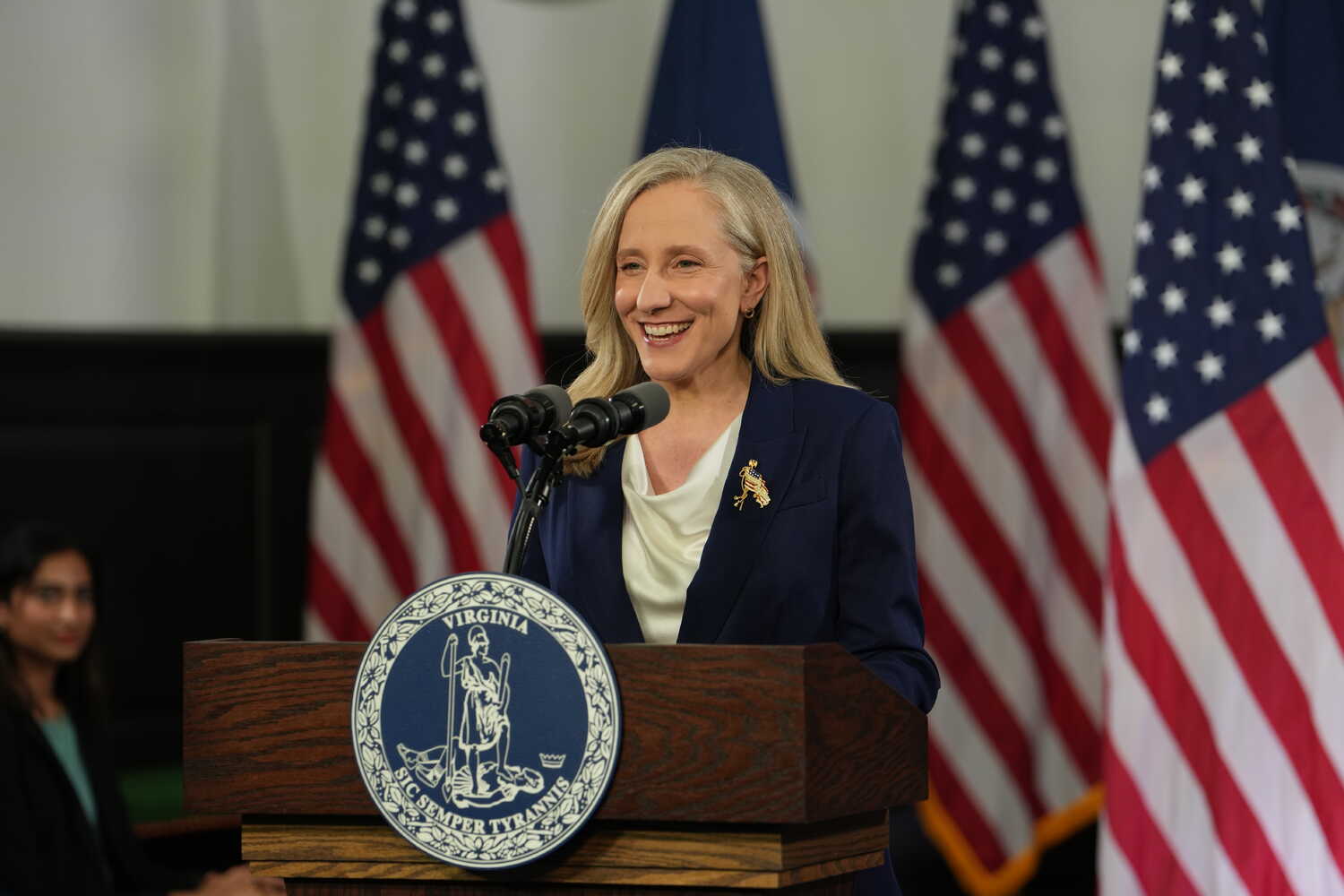Gov. Abigail Spanberger of Virginia smiling as she speaks at a lectern.