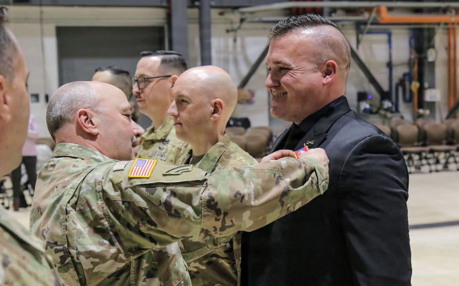 A man receives a military medal.