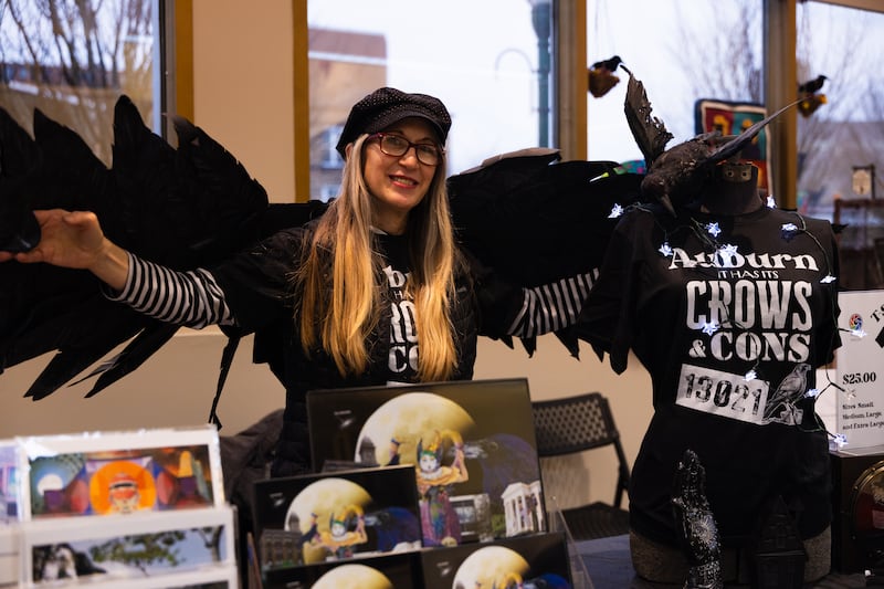 Artist and vendor Maureen McEver poses with her handmade crow wings. Vendors and attendees of Auburn's first Crow Cawcus on Saturday, Feb 21, dressed up in crow and supernatural themed costumes.
