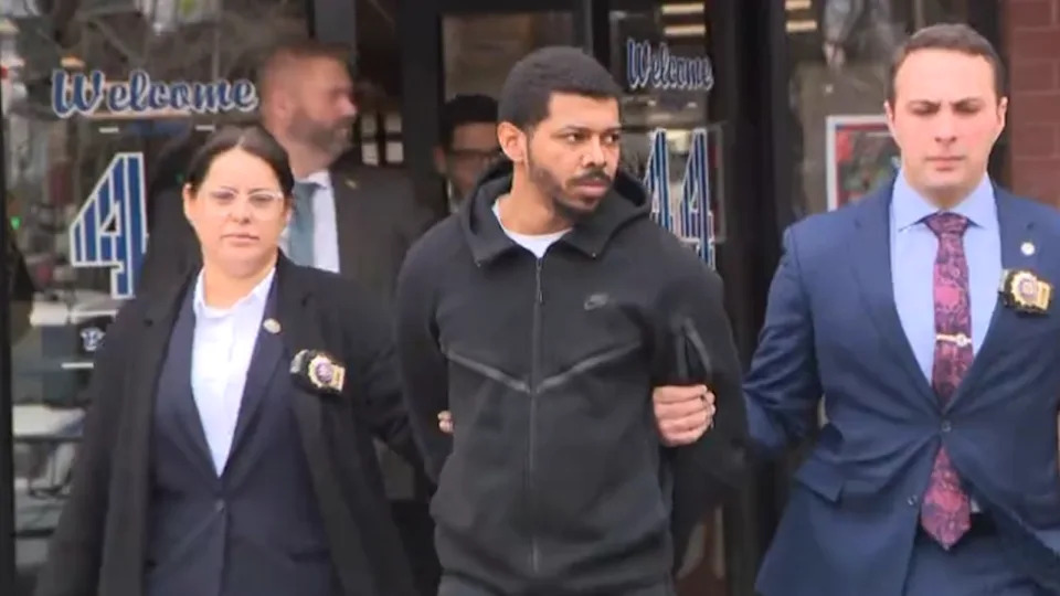 Alberto Frias, 27, is walked out of the 44th Precinct in the Bronx on Feb. 19, 2026. He is accused of fatally shooting a man in a Bronx subway station on Feb. 10, 2026. (Credit: PIX11 News)