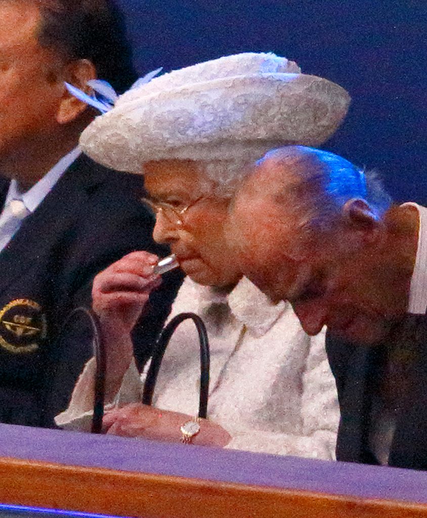 Queen Elizabeth II putting on her lipstick 