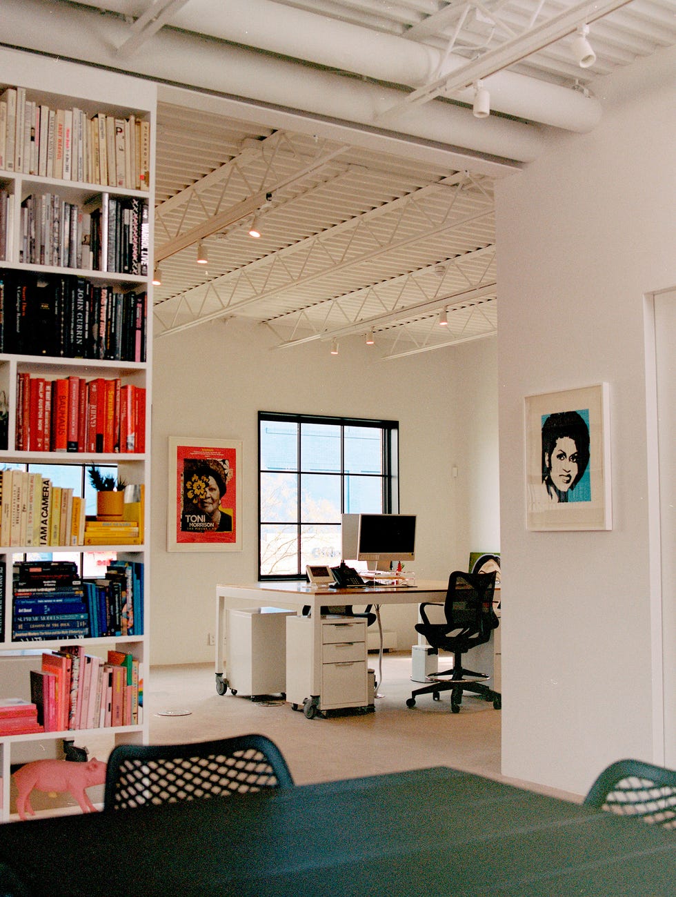 Modern office space with bookshelves and a work desk.