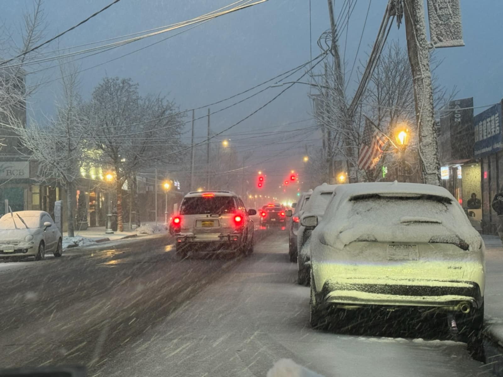 Vehicles navigate New Dorp Lane as snow falls around 5 p.m. on Sunday, Feb. 22, 2026.