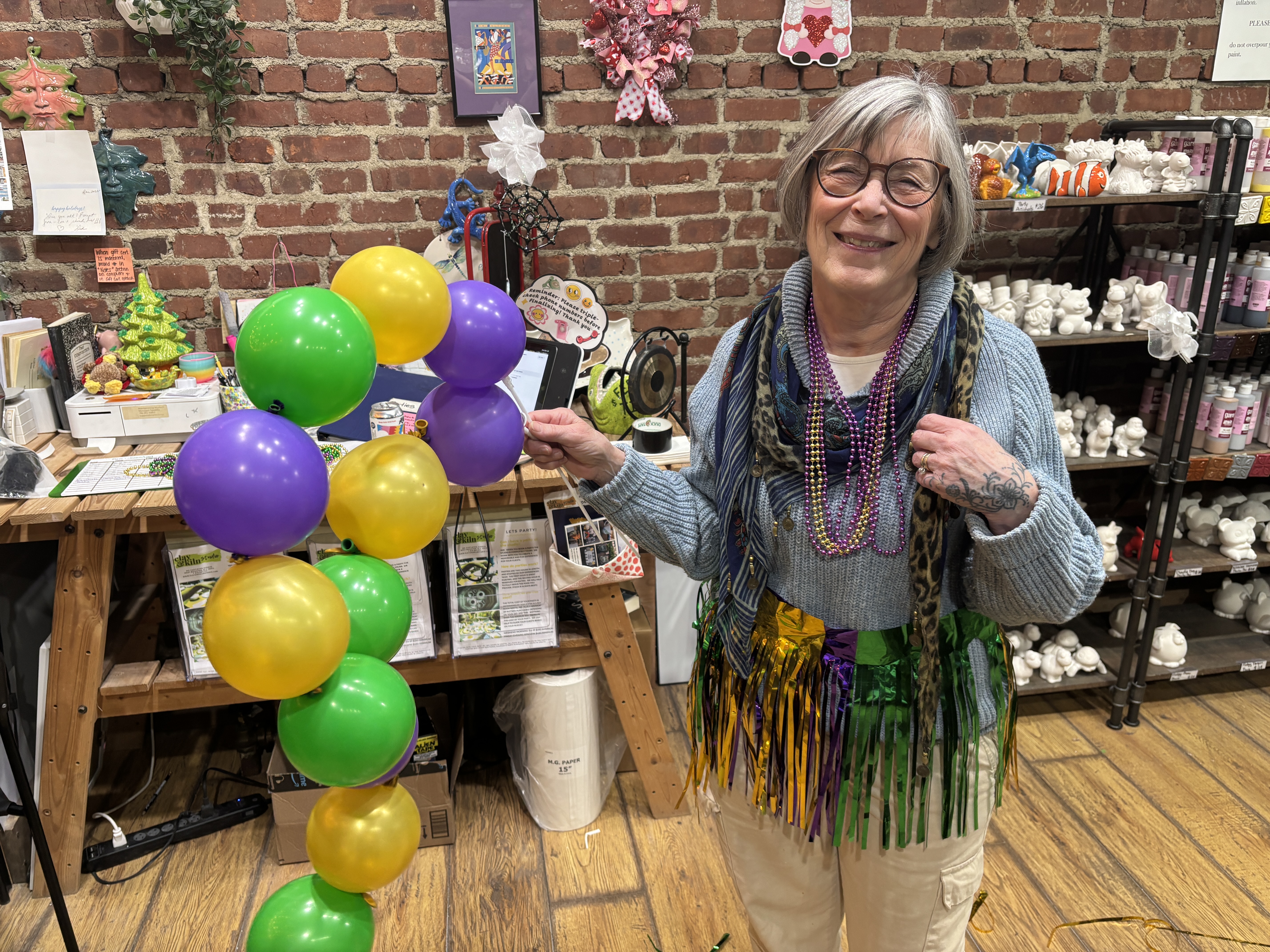 Mardis Gras 2026 happened on Castleton Avenue in West Brighton with King Cake, Hurricanes and local brews. Jean Daggan, co-owner of Clay & Kiln pottery studio danced and savored the moments with neighbors.